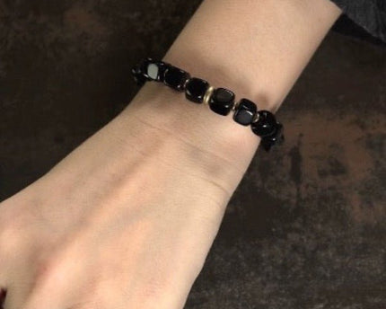 Zwarte obsidiaan blokken armband met bronzen armband