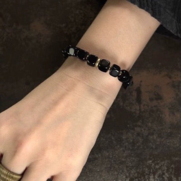 Zwarte obsidiaan blokken armband met bronzen armband