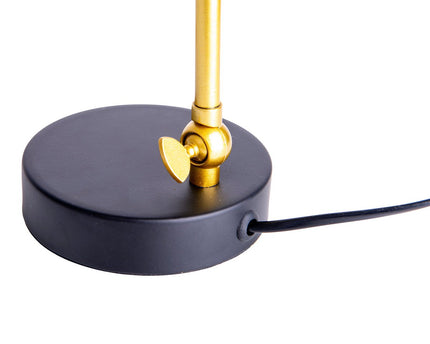 De "Triton" tafellamp gemaakt van zwart en messing gekleurd metaal is 42,5 cm hoog, heeft een E14-versie en is ideaal voor woonkamer, gang, kantoor of dessert